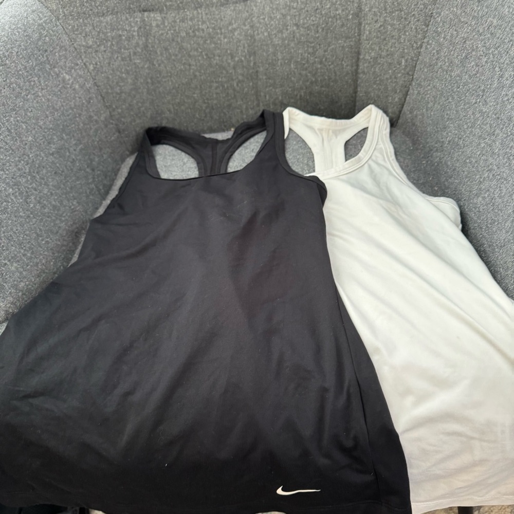 Two Nike active tanks in black and white size xs